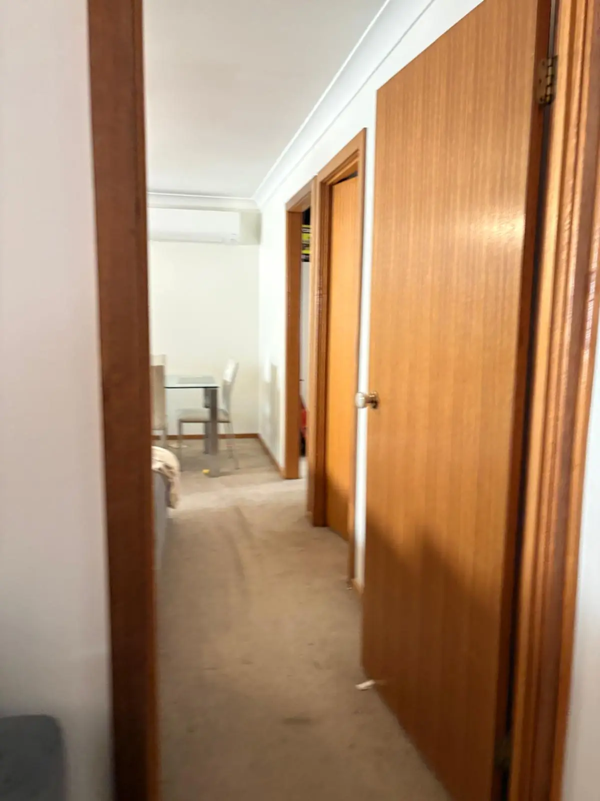 Tired long-term rental — internal hallway and bedroom flow